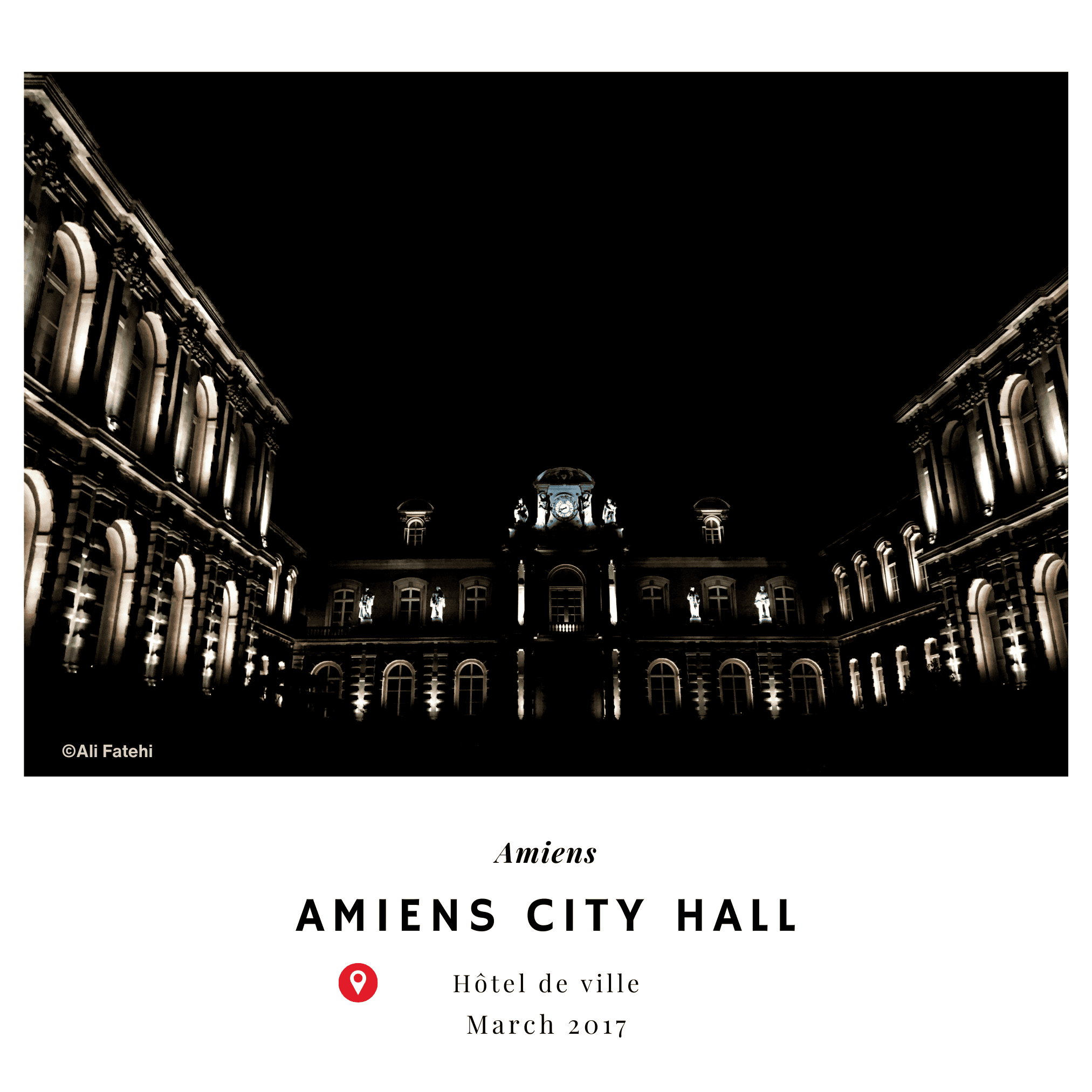 A night-time view of Amiens City Hall (Hôtel de Ville) illuminated, with the clock tower standing prominently in the center, taken in March 2017.