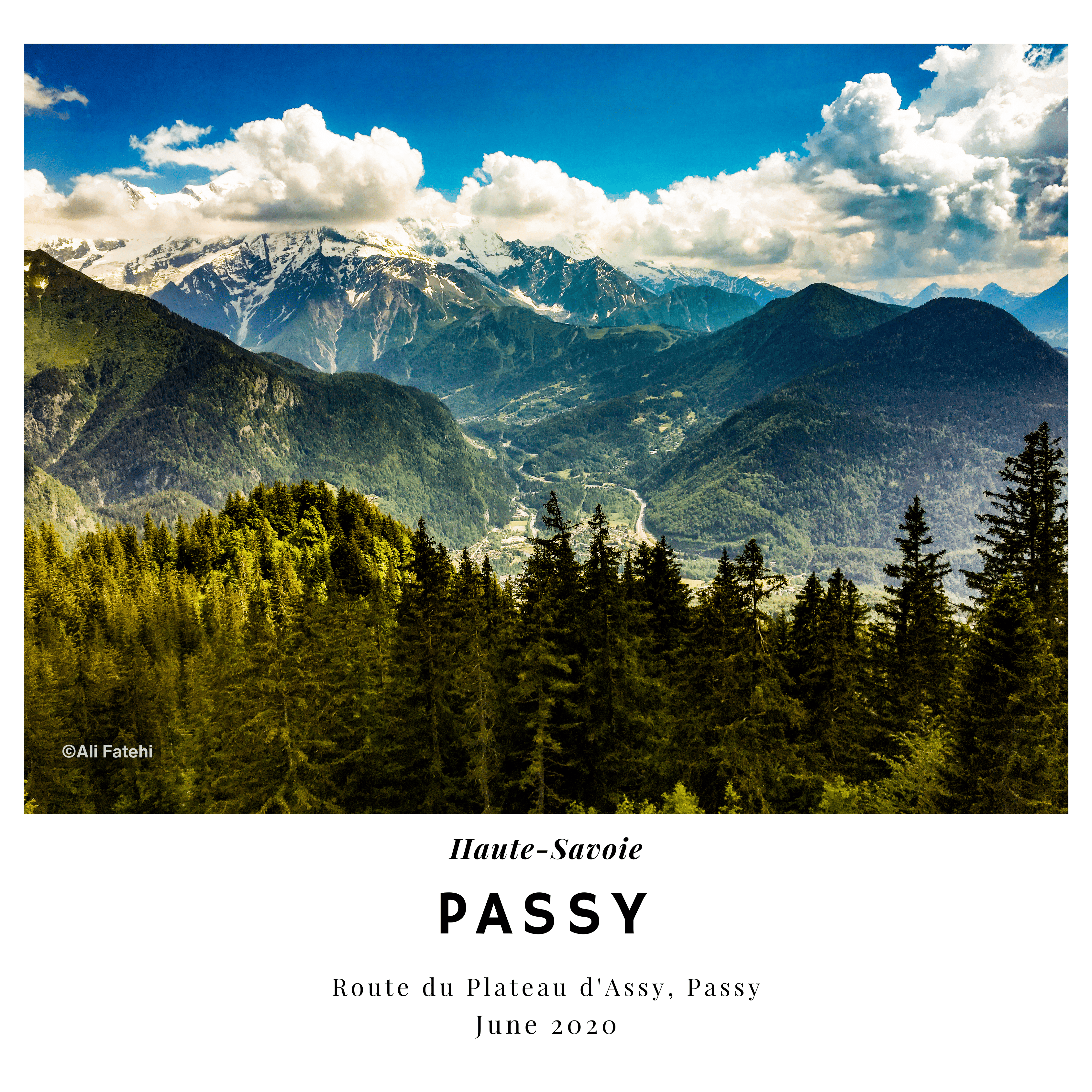 A panoramic view of the mountains in Passy, Haute-Savoie, with green forests in the foreground and snow-capped peaks in the background, taken in June 2020.