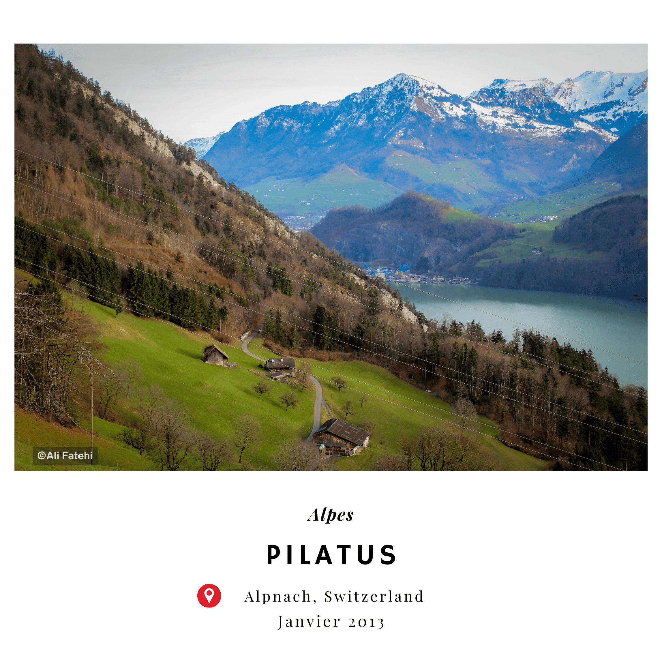 A view of the Pilatus mountains, with lush green fields, houses, and a lake in the foreground, taken in Alpnach, Switzerland, in January 2013.