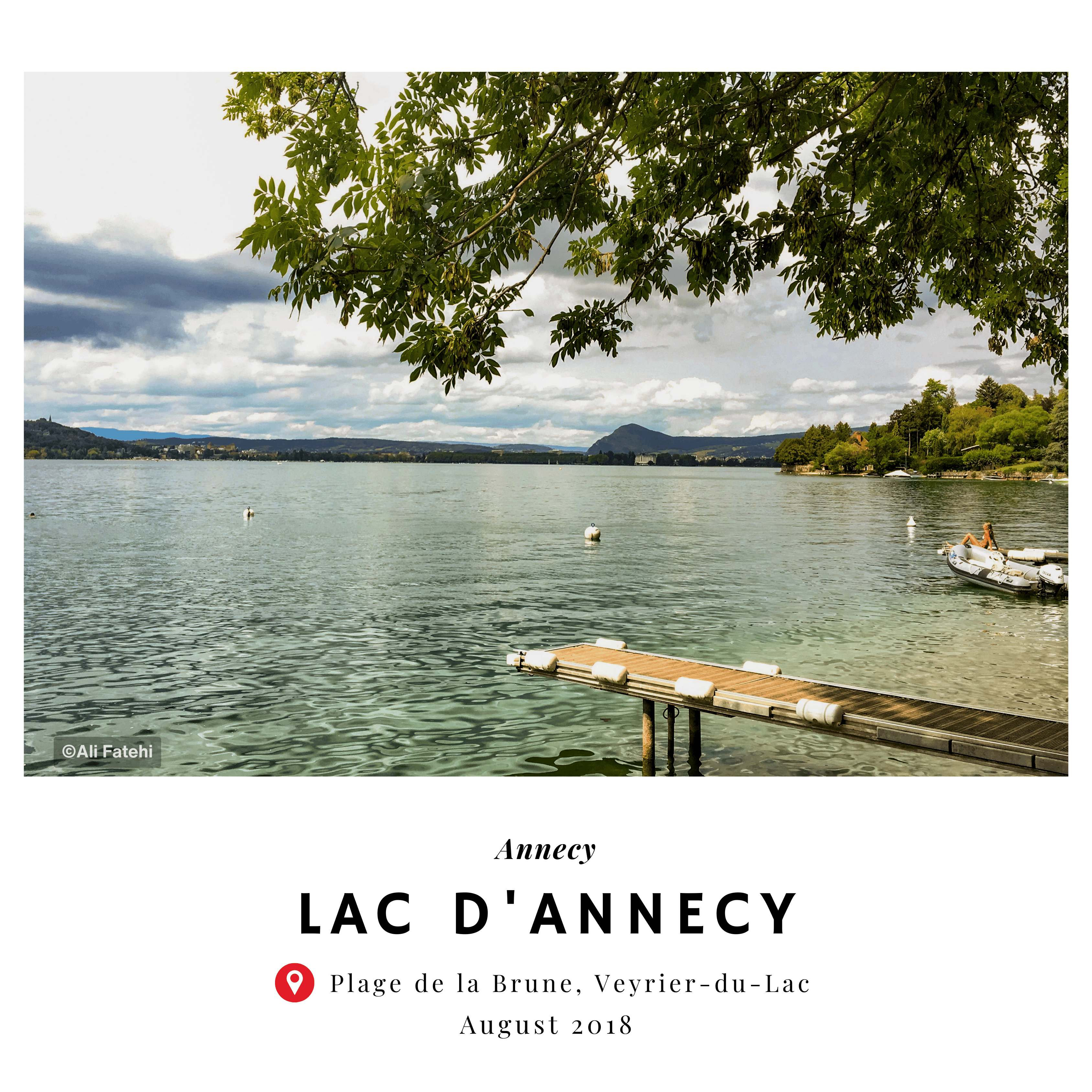 A view of Lake Annecy from Plage de la Brune, Veyrier-du-Lac, with a pier extending into the water, taken in August 2018.